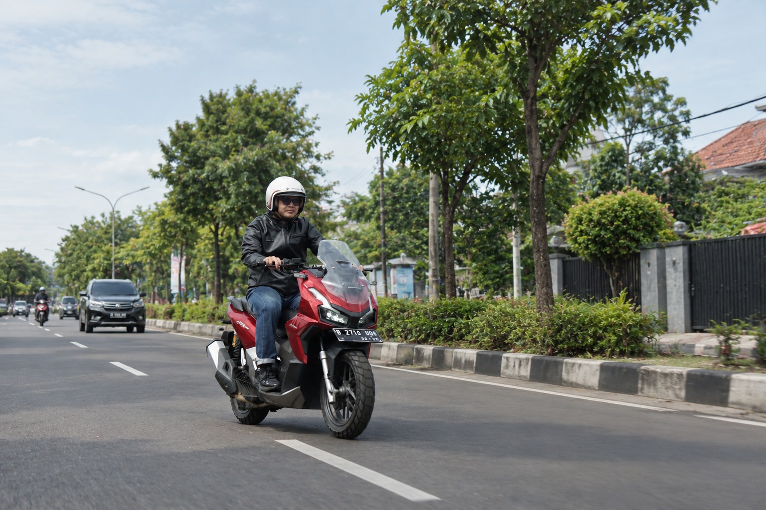 Red Scooter on a Green City Road (1)
